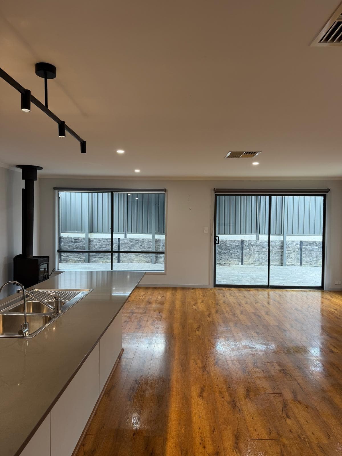 Spotless open-plan kitchen and living room with polished timber floors - end of lease clean Adelaide